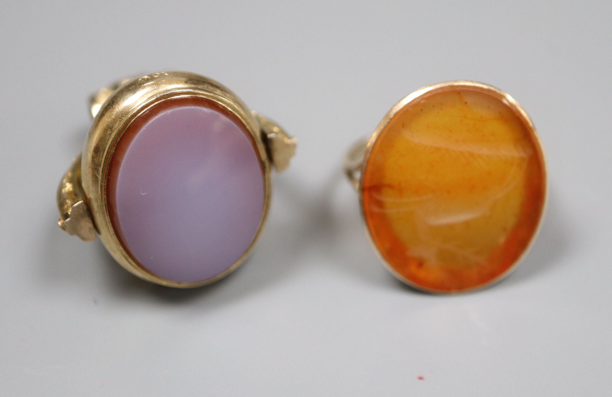 A Victorian 10ct and carnelian swivelling fob, 38mm and a similar yellow metal and carnelian ring